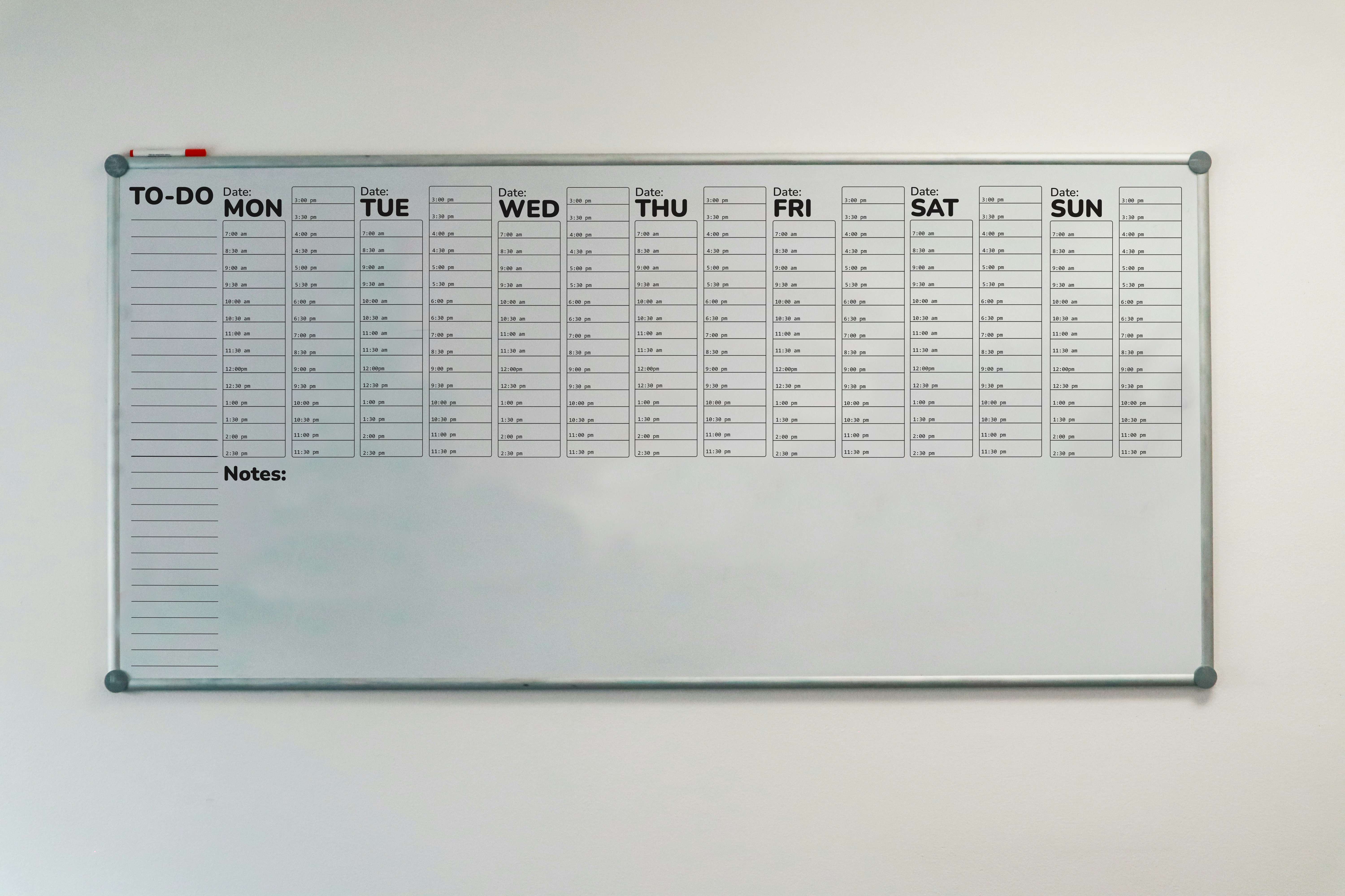 A white board with a todolistad blocked out schedual for a week